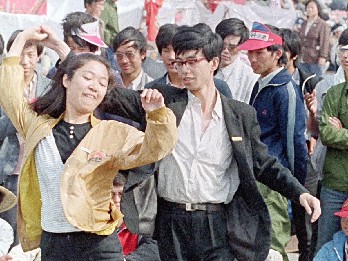 Two students dancing during the Tiananmen Square protests in 1989